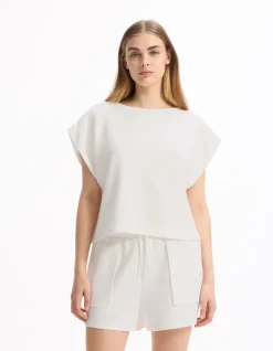 Celio T-shirt large sans manches - écru^Femme Sportswear
