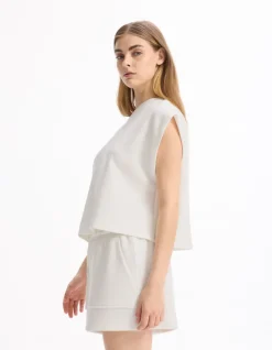 Celio T-shirt large sans manches - écru^Femme Sportswear
